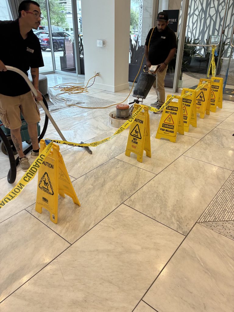 Stonewood team working on the marble floor at Aspire Post Oak